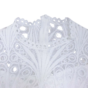 Detail of white lace dress showing stand collar with intricate hollow-out embroidery