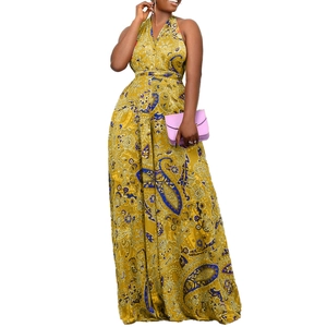 Macro detail of mustard yellow jumpsuit with paisley print and deep V-neckline halter top