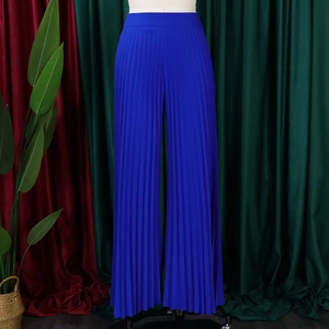 Detailed view of high-waisted pleated wide-leg trousers in vibrant royal blue fabric