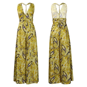Macro detail of mustard yellow paisley print halter neck jumpsuit with backless design