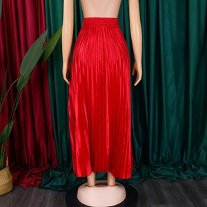 Detail of high waist elastic band on red pleated maxi skirt with silky satin finish