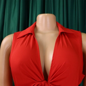 Detail of red deep V-neck sleeveless top with lapel collar and front knot design