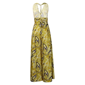 Detail of yellow backless wide-leg jumpsuit with purple and white Paisley print