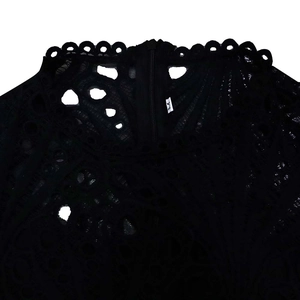 Detail of scalloped lace neckline on a black dress with size M label and zipper