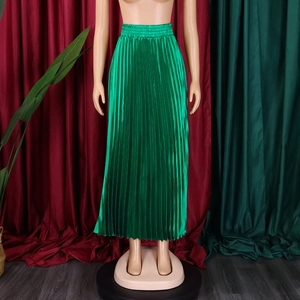 Detail of high waist pleated maxi skirt in emerald green with premium satin finish fabric
