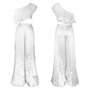 Detail of white two-piece set featuring pleated ruffles and wide-leg trousers in satin