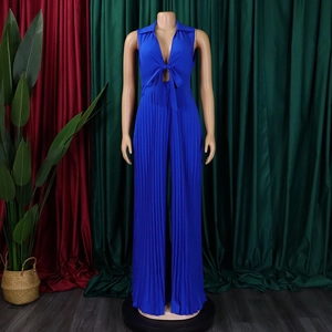 Detail of royal blue pleated wide-leg jumpsuit with deep V-neck and bow tie detail