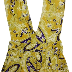 Detail of yellow paisley print with deep V-neck and intricate floral textures on fabric