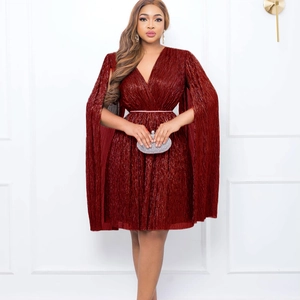 Detail of burgundy V-neck pleated dress with cape sleeves and sparkling belt