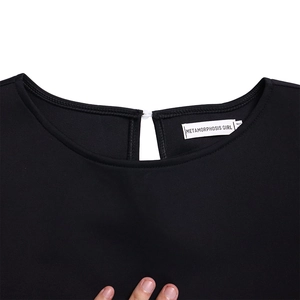 Detail of black puff sleeve dress back neckline with keyhole cutout and single button