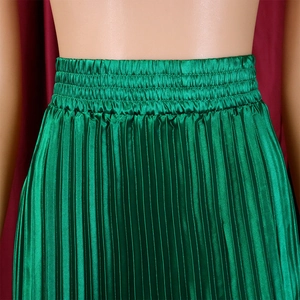 Detail of high waist elastic band on emerald green pleated satin maxi skirt with fine texture