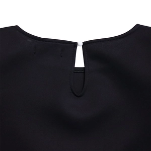 Detail shot of black dress back neckline with keyhole opening and white button closure