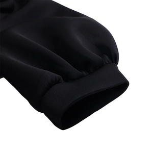 Detailed view of black puff sleeve cuffs with elastic shirring on this slim fit dress
