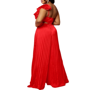 Detail of red off-shoulder ruffled top and pleated wide-leg pants with cut-out waist