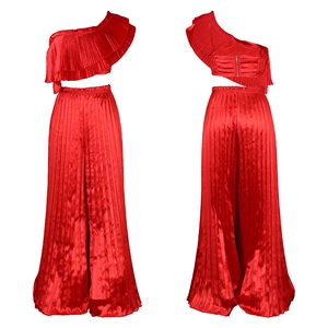 Detail view of red off-shoulder pleated crop top and matching high-waisted wide-leg trousers