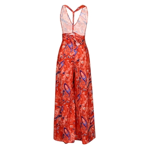 Detail of red paisley printed jumpsuit with backless tie-up bow and wide legs