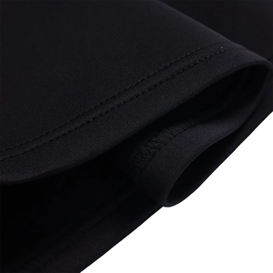 Detailed close-up of high-quality double-needle stitching on black knitted dress fabric