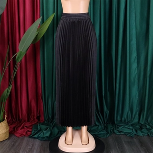 Detail of high-waisted black pleated maxi skirt with elastic waistband and flowy A-line silhouette