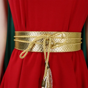 Close-up of gold snake-pattern wide belt with metallic woven rope and tassel detail