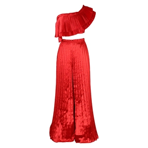 Detail of red pleated two-piece set featuring one-shoulder ruffle top and wide-leg trousers