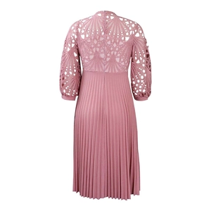 Detail of dusty rose lace hollow out patterns and pleated fabric on midi dress