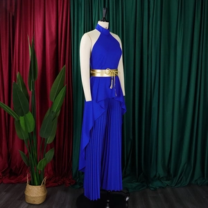 Close-up of royal blue pleated wide-leg trousers with a gold braided tassel waist belt