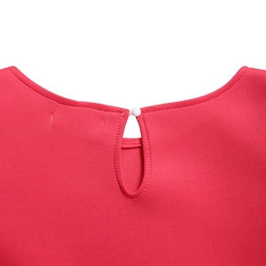 Close-up of rose red dress featuring round neckline with pearl button and teardrop cutout