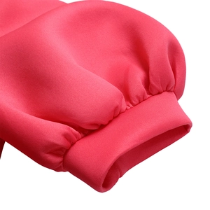 Detail shot of puffy sleeves with tight ribbed cuffs on this hot pink dress