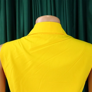 Detail of a bright yellow sleeveless shirt collar and shoulder lines on a mannequin