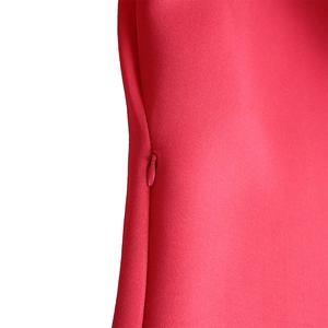 Detailed view of the invisible back zipper on this solid red puff sleeve dress