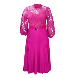 Detail of rose pink lace crochet patterns and pleated skirt texture with a metal buckle belt