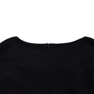 Detail view of the back neckline with a hidden zipper on this black mesh dress