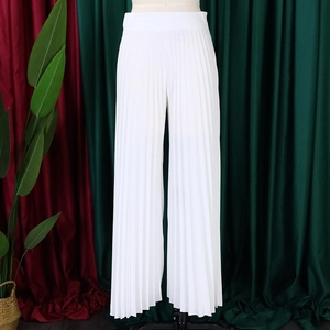 Detailed view of white high-waisted pleated wide-leg trousers with vertical texture
