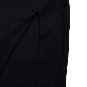 Close-up of side slit detail on black pleated mesh dress with precise stitching work