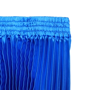 Close-up of high-waist elastic band and fine pleated texture on royal blue midi skirt
