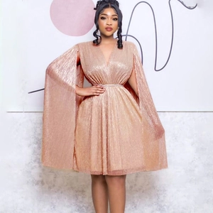 Detail of rose gold pleated V-neck cape dress with metallic sheen and waist belt