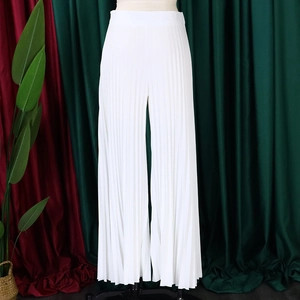 Detail of high-waisted white pleated wide-leg pants showing the vertical crinkle texture