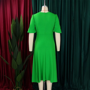 Back view of a vibrant green round neck short sleeve midi dress on a mannequin