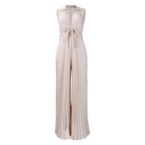 Detail of elegant beige pleated jumpsuit featuring a deep V-neck and stylish waist tie