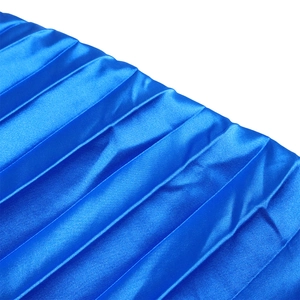 Macro detail of royal blue pleated satin fabric with high gloss and elegant texture