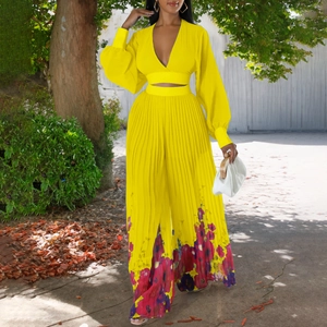 Detail of yellow V-neck chiffon top and floral printed pleated wide-leg trousers