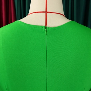 Detail of the bright green dress featuring a back invisible zipper and textured fabric