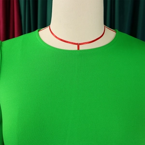 Detailed view of the bright green round neck dress featuring textured crepe fabric