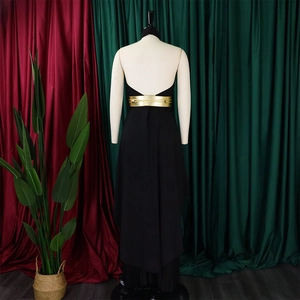 Detail of black backless halter maxi dress with decorative wide gold waist belt on mannequin