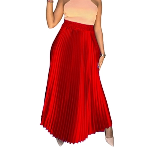 Close-up of red pleated maxi skirt showing fine satin texture and high elastic waistband