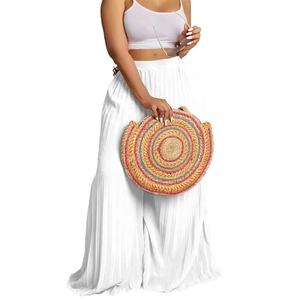 Detail view of white high-waisted pleated wide-leg pants with accordion pleat texture