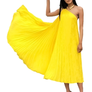 Elegant bright yellow pleated one-shoulder maxi dress with voluminous flared skirt hem