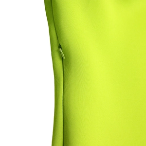 Detail of the hidden zipper and smooth fabric on the bright green bodycon dress