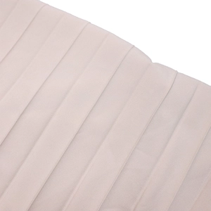 Detail shot of the vertical pleated fabric on a light beige V-neck long sleeve jumpsuit