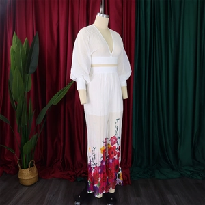 Detail of white v-neck chiffon top and wide-leg pants with colorful floral print
